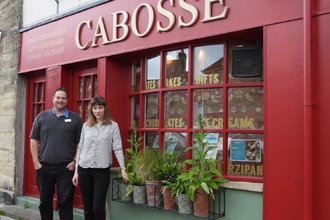 Alex Lister, Northumberland Wildlife Trust’s Wilder Druridge Manager with Louise Keeble, Cabosse owner and chocolate creator, standing outside of the Cabosse storefront.
