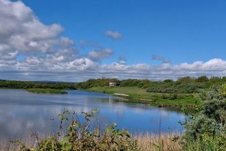 View of Hauxley Wildlife Discovery Centre from the lake. Image by Lauren Brough.