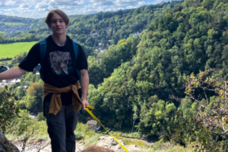 Eddie on a hike with a dog on a lead.