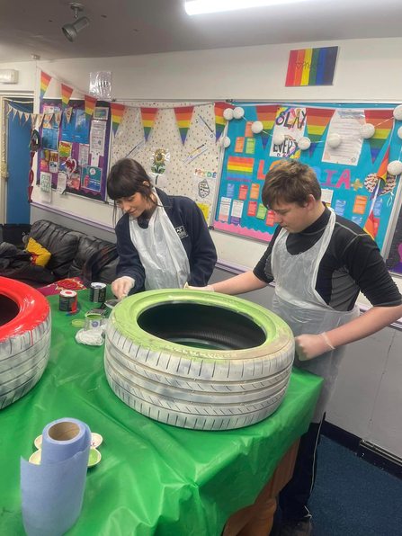 Demmi Robinson, NWT Eco Mentor painting tyres at the Amble Young Project. Image by: Demmi Robinson.