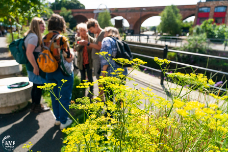 A small group touring Ouseburn on a bright, sunny day.