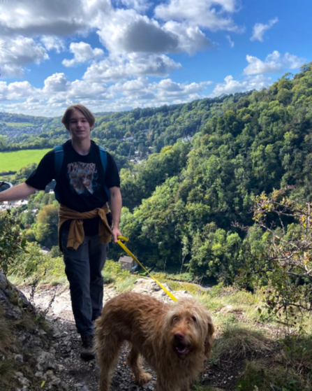 Eddie on a hike with a dog on a lead.